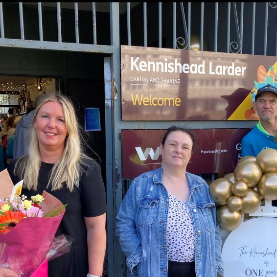 Chris Stephens MP, Kennishead Larder Co-ordinator Suzanne Oliver and tenants standing outside in front of Kennishead Larder